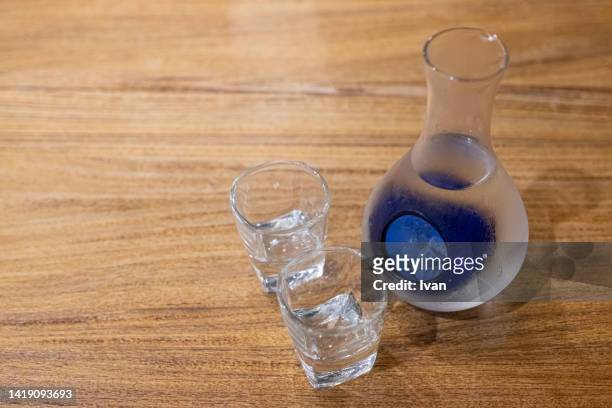 iced sake serviced in glass bottle - hard liquor stock pictures, royalty-free photos & images
