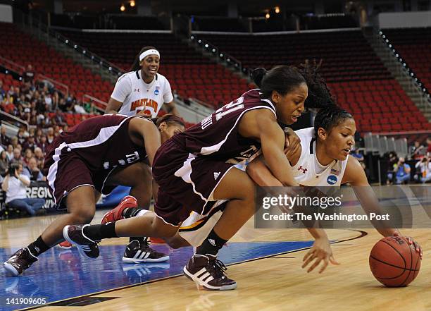 Texas A&amp;M Aggies forward Adaora Elonu , left, get tangled up with Maryland Terrapins forward Alyssa Thomas as they battle for a loose ball under...