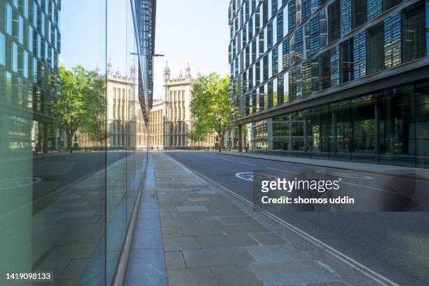 empty street amidst buildings in london financial district - empty road stock pictures, royalty-free photos & images