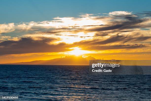 Sunset is visible over the island of Lanai, viewed from Wailea Beach on the island of Maui, Kihei, Hawaii, July 28, 2022. Photo courtesy Sftm.