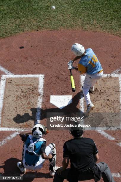 Kama Angell of the West Region team from Honolulu, Hawaii hits a home run during the first inning of the Little League World Series Championship game...