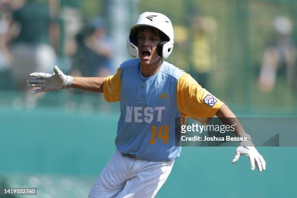 Kama Angell of the West Region team from Honolulu, Hawaii celebrates after hitting a home run during the first inning of the Little League World...