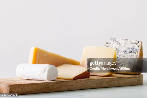 close-up of cheese on white background - cheddar cheese stock pictures, royalty-free photos & images
