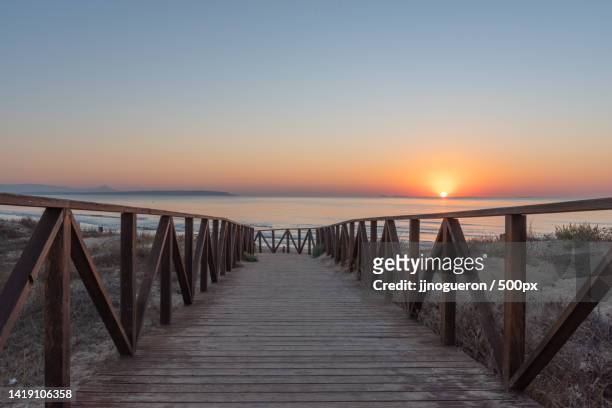 sunrise on the wooden boardwalks of the beach,alicante,spain - alicante spain stock pictures, royalty-free photos & images