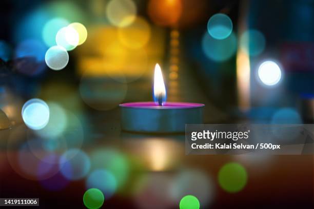 close-up of illuminated tea light candles on table,chennai,tamil nadu,india - tea light stock pictures, royalty-free photos & images