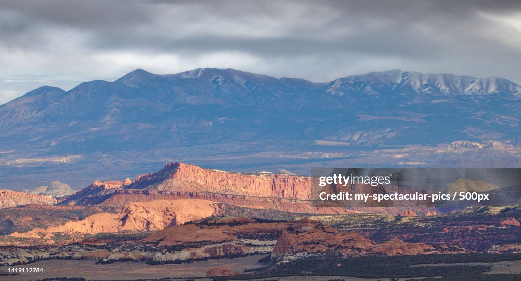 Scenic view of mountains against cloudy sky