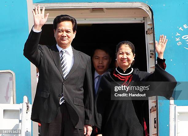 In this handout image provided by Yonhap News, Vietnamese Prime Minister Nguyen Tan Dung and his wife Tran Thanh Kiem arrive at Seoul Airport to...