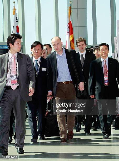 In this handout image provided by Yonhap News, Polish Environment Minister Marcin Korolec arrives at Incheon International Airport to attend the 2012...
