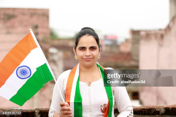 indian women waving flag at home portrait close up - indian tricolor stock pictures, royalty-free photos & images