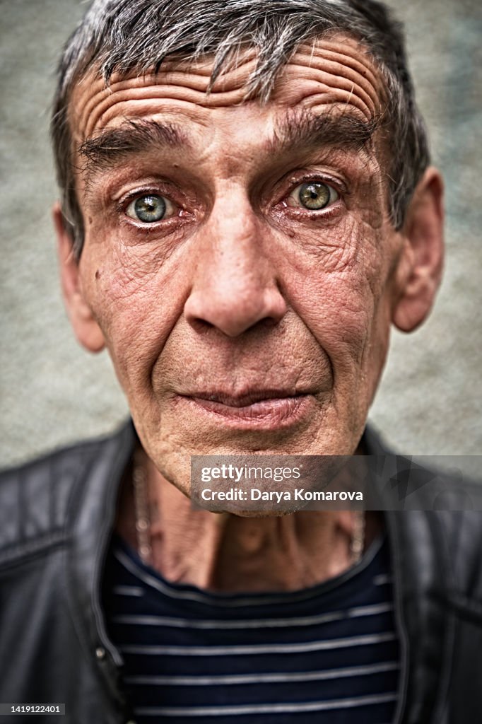 A portrait of an elderly Russian man, a worker, a man with blue eyes.