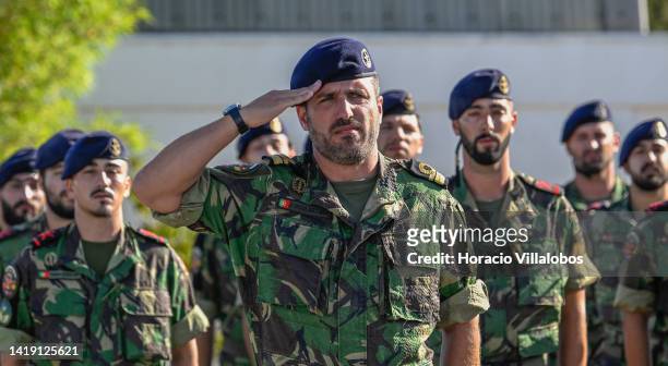 Lieutenant-Commander João Gomes Goulart, head of the Marines force returning from Lithuania, salutes as the national anthem is being played during...