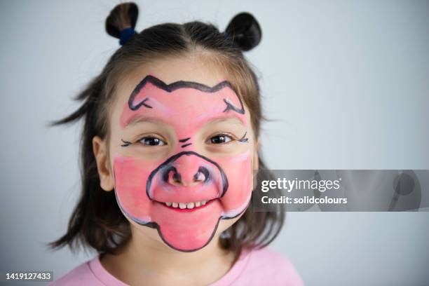 little girl with pig makeup on her face - animal makeup stock pictures, royalty-free photos & images