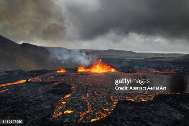 lava erupting from a volcano shot from a drone, iceland - volcanic activity - fotografias e filmes do acervo