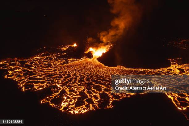 drone image close to an erupting volcano at night, iceland - active volcano stock pictures, royalty-free photos & images