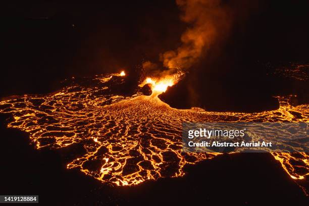 drone image close to an erupting volcano at night, iceland - vulcão ativo imagens e fotografias de stock