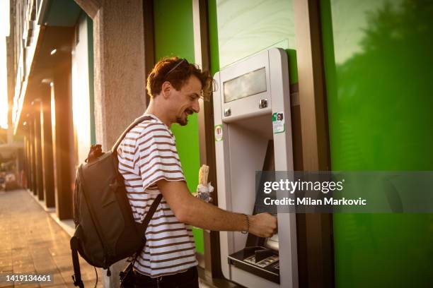 i will check my account balance - man atm smile stock pictures, royalty-free photos & images