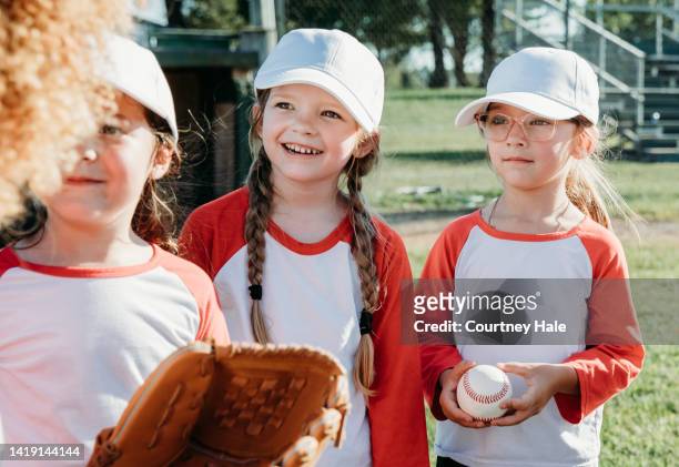 baseball team of little girls learning how to play sport from coach - girl baseball cap stock pictures, royalty-free photos & images