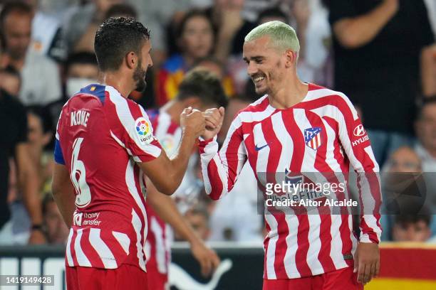 Antoine Griezmann of Atletico de Madrid celebrates with teammate Koke after scoring their team's first goal during the LaLiga Santander match between...