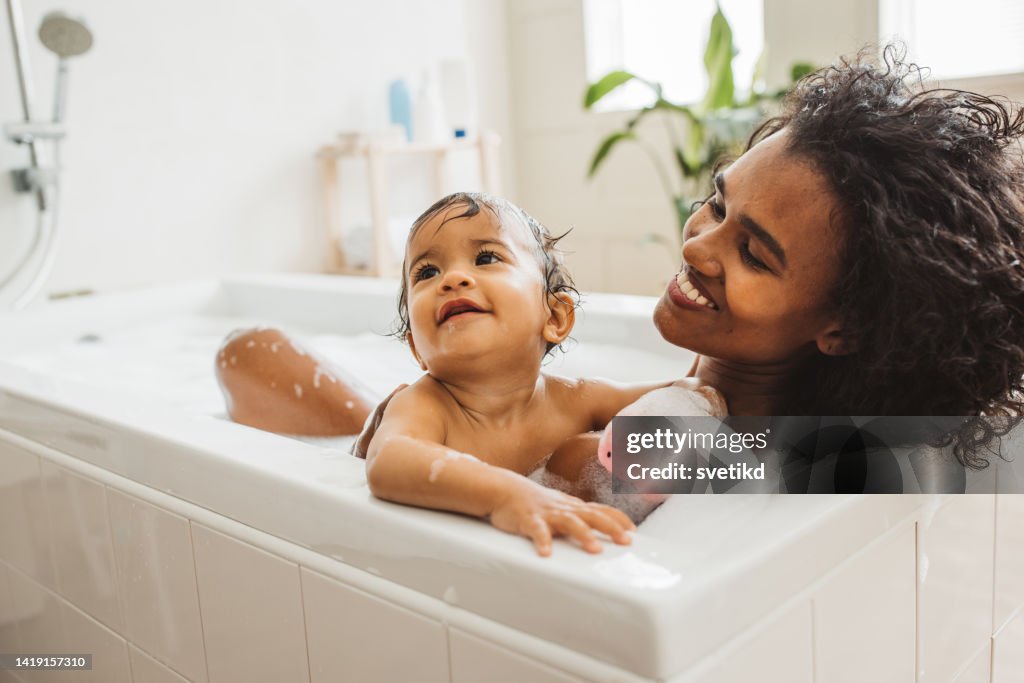 Mother and baby bathing