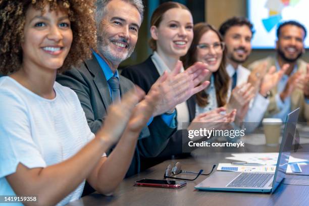 group of business people applauding a presentation. - applauding staff stock pictures, royalty-free photos & images