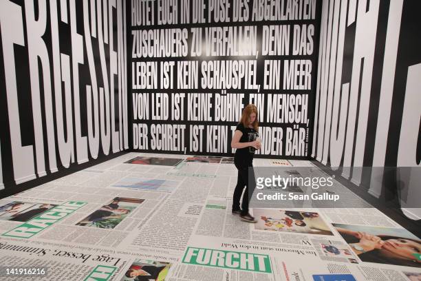 Young woman walks through an installation by artist Barbara Kruger at the exhibition "ARTandPRESS" at Martin Gropius Bau on March 26, 2012 in Berlin,...