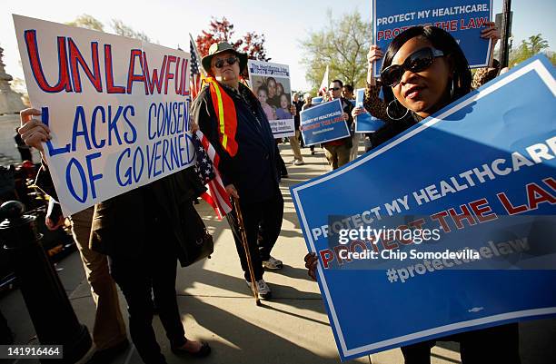 Demonstrators for and against the Patient Protection and Affordable Care Act march and chant in outside the U.S. Supreme Court Building on March 26,...