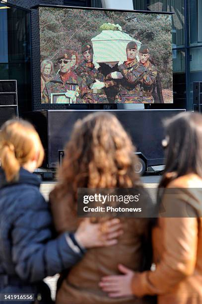 Members of the public watch broadcast of the the ceremony outside the Soeverein Arena during the funeral ceremony for those who died in the Sierre...