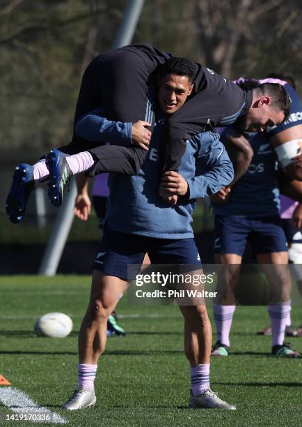 Roger Tuivasa-Shec of the All Blacks holds up Will Jordan during a New Zealand All Blacks Training Session at Beetham Park on August 30, 2022 in...