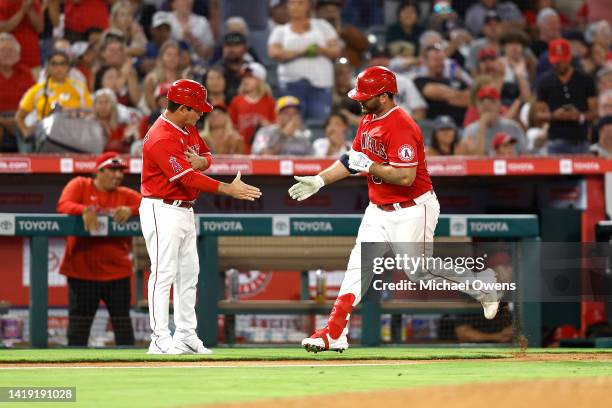 Mike Ford of the Los Angeles Angels celebrates his solo home run with third base coach Mike Gallego against the New York Yankees in the fourth inning...