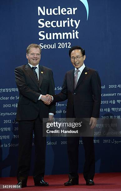 In this handout image provided by Yonhap News, Finnish President Sauli Niinisto and South Korean President Lee Myung-bak pose at the welcoming...