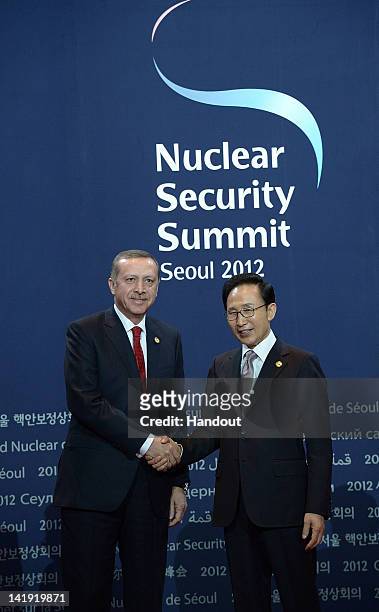 In this handout image provided by Yonhap News, Turkish Prime Minister Recep Tayyip Erdogan and South Korean President Lee Myung-bak pose at the...