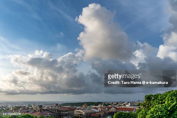 summer clouds over the residential district by the sea in naha city of japan - sea ​​of ​​clouds stock pictures, royalty-free photos & images