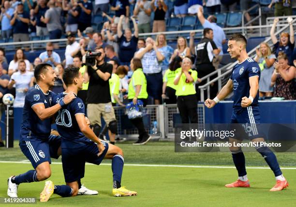 Roger Espinoza, Daniel Salloi and Erik Thommy of Sporting Kansas City celebrate Sallois goal in the first half during a game between San Jose...