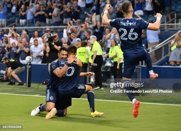 Roger Espinoza, Daniel Salloi and Erik Thommy of Sporting Kansas City celebrate Sallois goal in the first half during a game between San Jose...