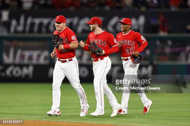 Mike Trout, Taylor Ward and Magneuris Sierra of the Los Angeles Angels celebrate a 4-3 win over the New York Yankees in the ninth inning at Angel...