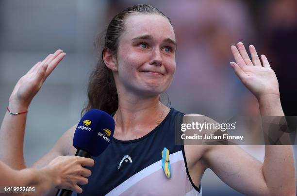 Daria Snigur of Ukraine reacts after defeating Simona Halep of Romania during the Women's Singles First Round on Day One of the 2022 US Open at USTA...