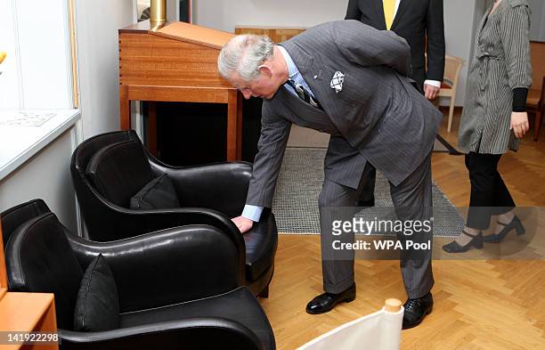 Prince Charles, Prince of Wales tries out a chair during a visit to the Rud Rasmussen furniture warehouse on March 26, 2012 in Copenhagen, Denmark....