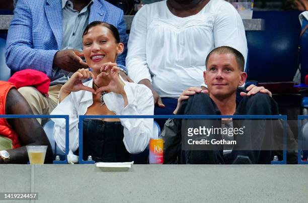 Bella Hadid and Marc Kalman look on during the Women's Singles First Round match between Serena Williams of the United States and Danka Kovinic of...