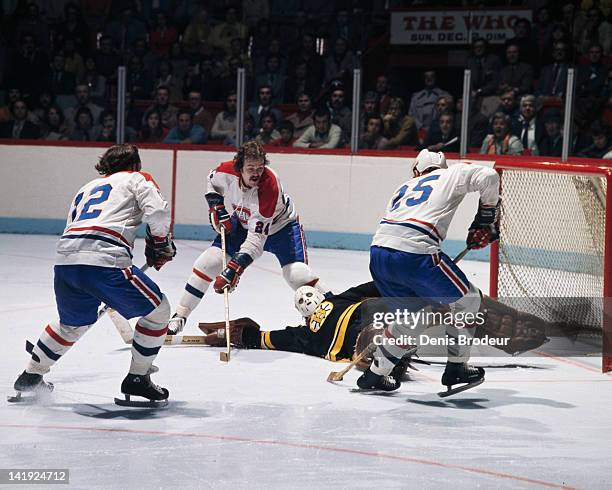 Chuck Lefley, Jaques Lemaire and Yvan Couroyer of the Montreal Canadiens all look for a rebound near the Boston Bruins net Circa 1970 at the Montreal...