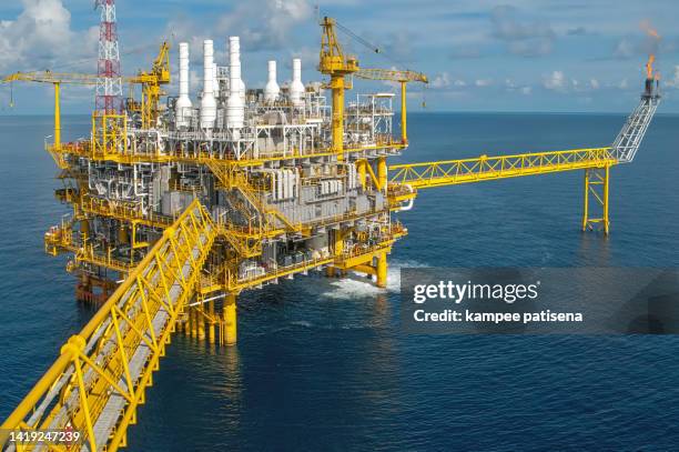 oil and gas platform with gas burning, power energy. - oil production platform stock pictures, royalty-free photos & images