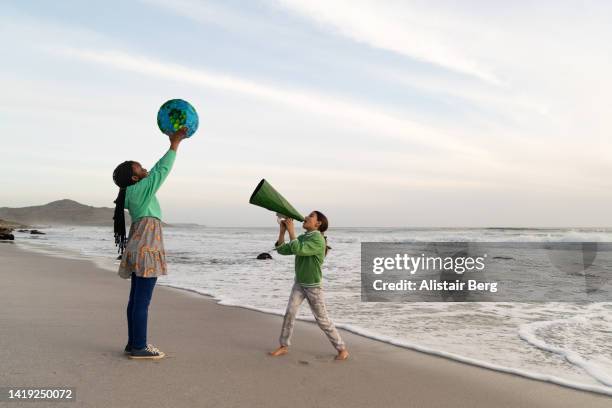 eco warrior superhero shouting into megaphone - earth activist stock pictures, royalty-free photos & images