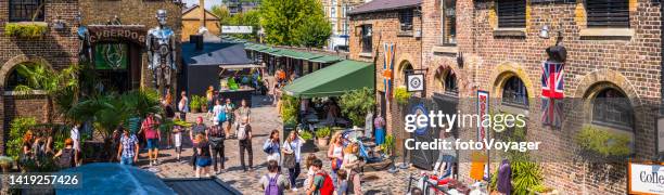 london crowds of shoppers at camden market cobbled courtyards panorama - westminster maryland stock pictures, royalty-free photos & images