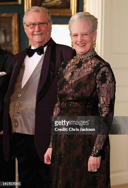 Queen Margarethe II of Denmark and Prince Consort Henrik of Denmark take part in a receiving line ahead of an official dinner at the Royal Palace on...