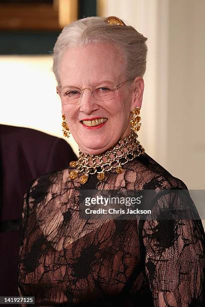 Queen Margarethe II of Denmark takes part in a receiving line ahead of an official dinner at the Royal Palace on March 26, 2012 in Copenhagen,...