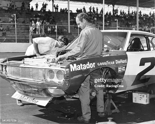 Early-1970s: Driver Dave Marcis helps work on the Roger Penske Racing AMC Matador on pit road at Martinsville Speedway before a NASCAR Cup race....