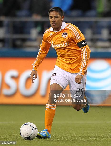 Brian Ching of the Houston Dynamo dribbles against the Seattle Sounders at CenturyLink Field on March 23, 2012 in Seattle, Washington.