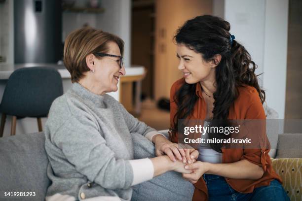 happy mother and daughter smiling together - mature woman daughter stock pictures, royalty-free photos & images