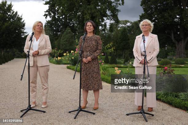 German Interior and Homeland Minister Nancy Faeser, Foreign Minister Annalena Baerbock and Defense Minister Christine Lambrecht speak to the media at...