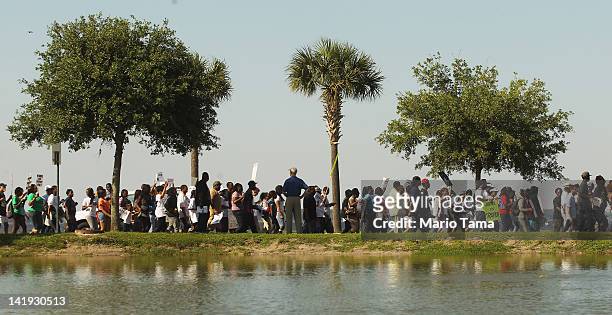Trayvon Martin supporters march before the start of a town hall meeting about Martin’s death on March 26, 2012 in Sanford, Florida. The teenager's...