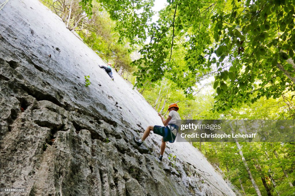 Teenagers rock climbing, France